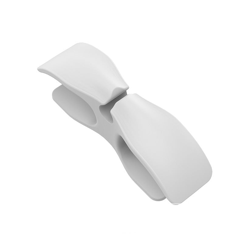 White plastic cable cord organizer on a white background