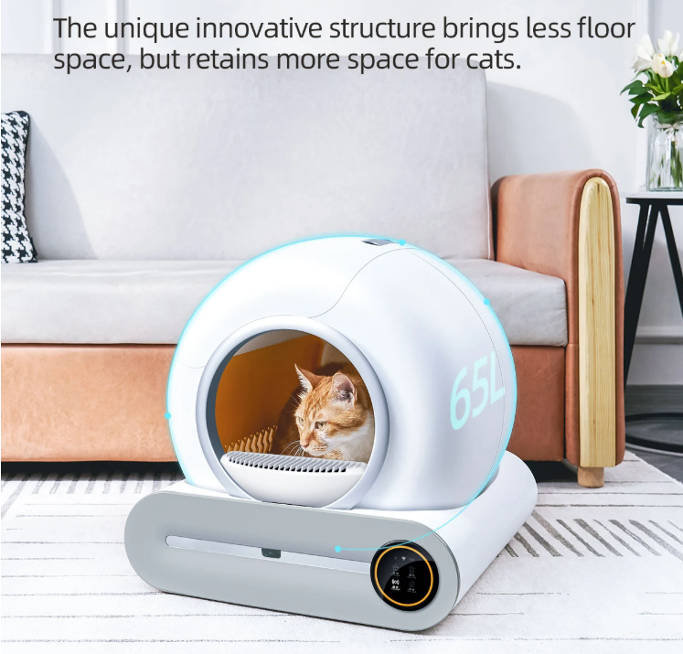 A modern self-cleaning cat litter box with a cat inside, placed on a wooden floor in a living room setting.